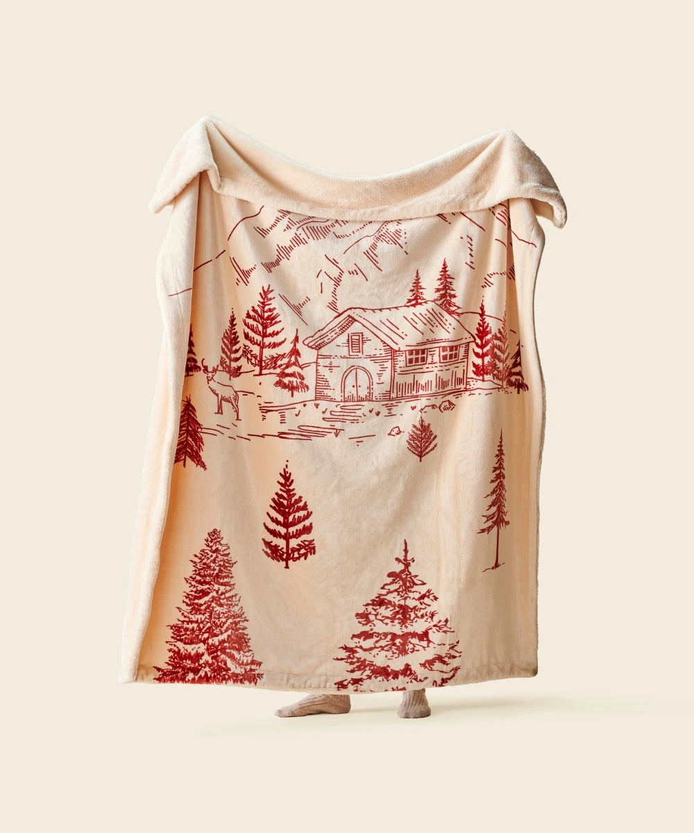 Plaid polaire alpine lodge waro tendu par une personne sur un fond beige 