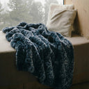 Plaid fausse fourrure nuit fauve posé sur un banc