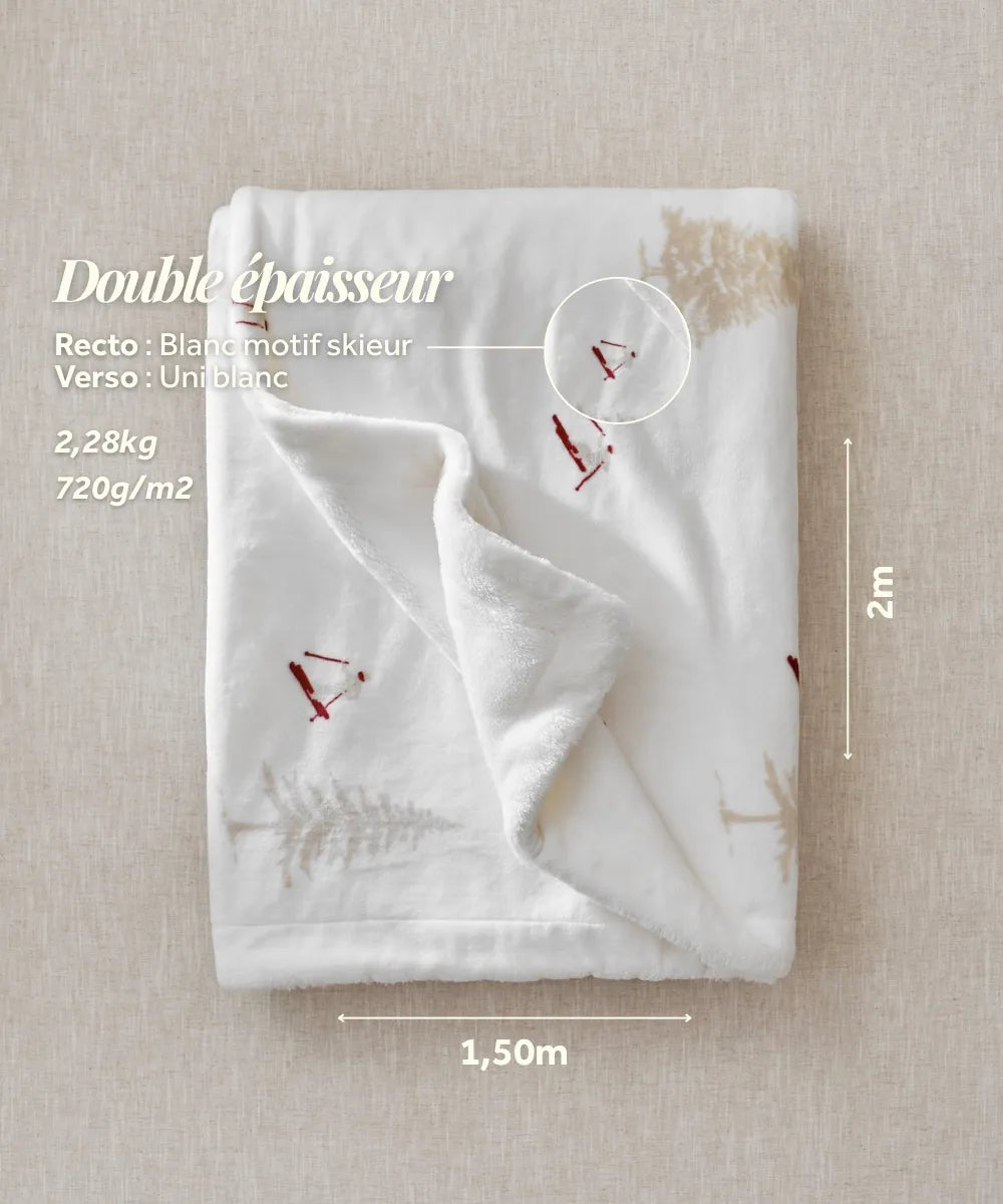 The white plaid with a waro skier motif adds a cosy alpine touch to your moments of relaxation.