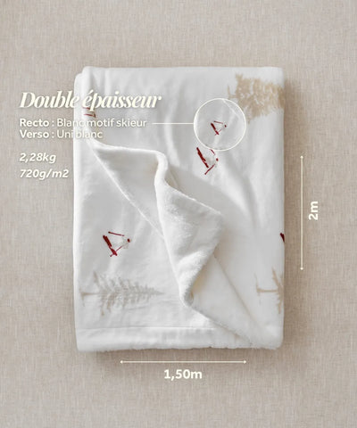 The white plaid with a waro skier motif adds a cosy alpine touch to your moments of relaxation.
