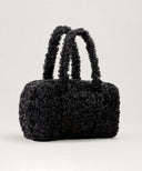 Sac weekendermotif teddy noir waro posé sur un fond beige 