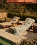 fouta lin bleu posee sur un bain de soleil