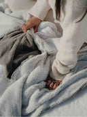 Gros plan sur la texture du plaid cosy bicolore givre gris clair WARO, tissu ultra doux et confortable