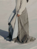 Detail of WARO's cosy two-tone frosted plaid in light grey, soft and thick on the outside.
