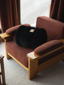 Black panther faux fur plaid on a wooden armchair for a cosy atmosphere