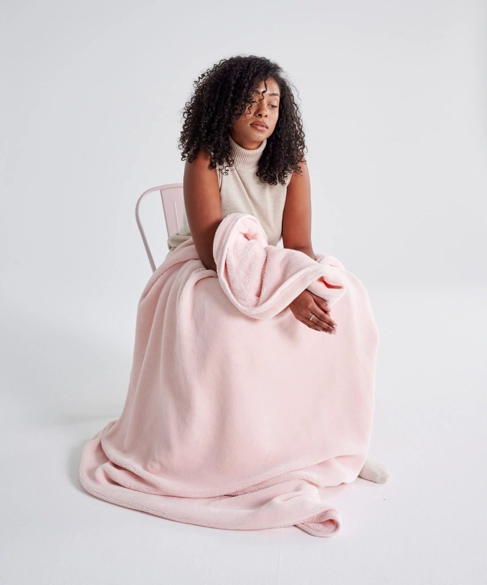 Cosy powder pink fleece waro on a woman's lap