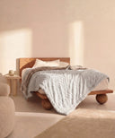 Plaid polaire tigre beige  waro posé sur un lit