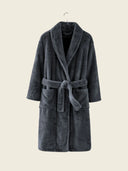 Grey WARO hotel bathrobe in faux fur, worn in a spa-like bathroom.